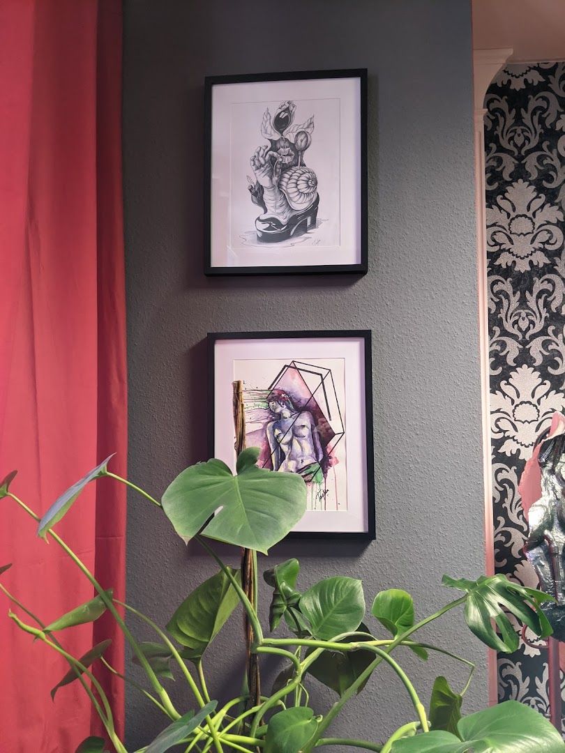 a plant in a pot next to a picture of a woman