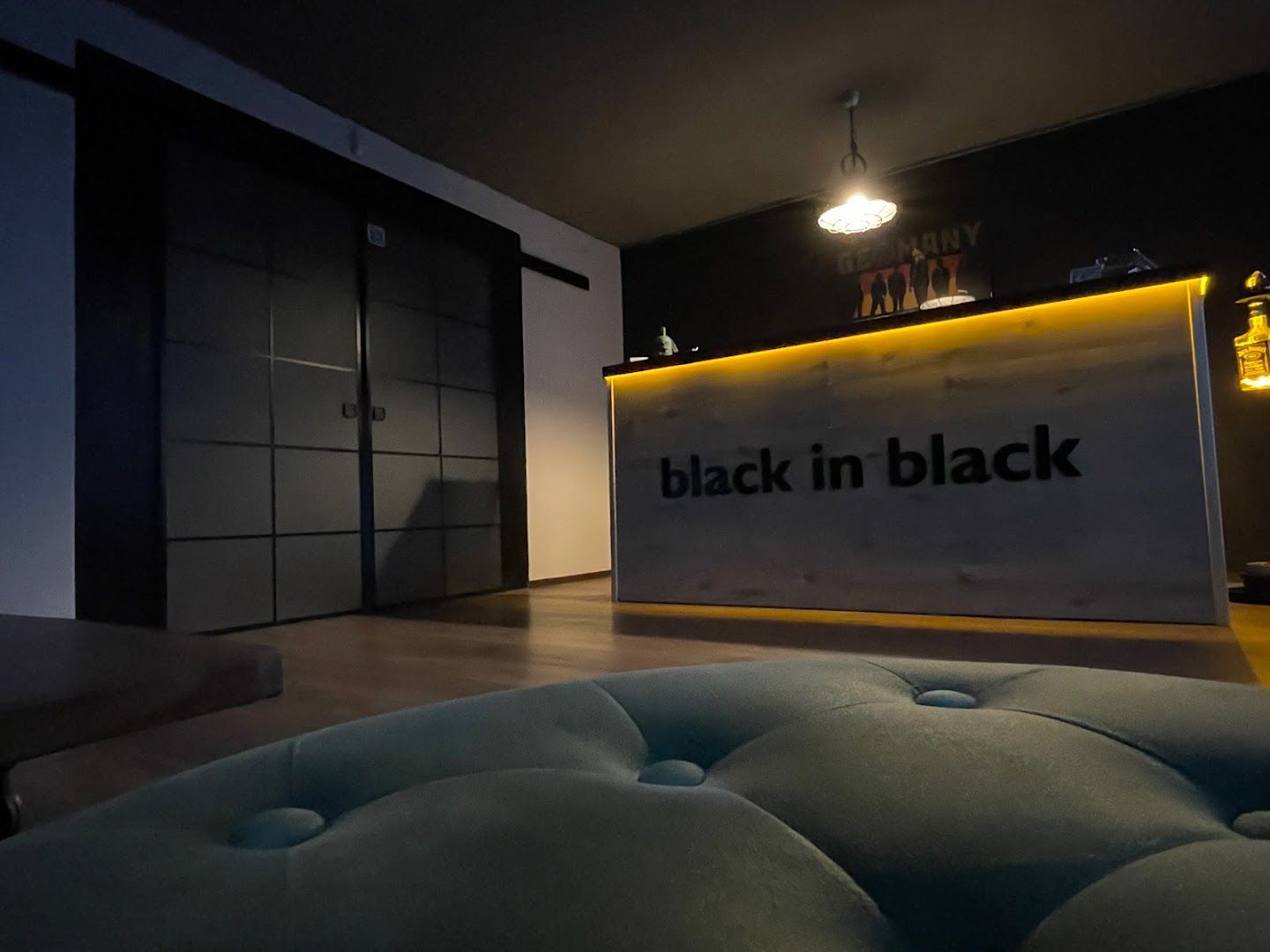 a black and white reception area with a neon sign