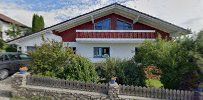 a house with a red roof and white walls