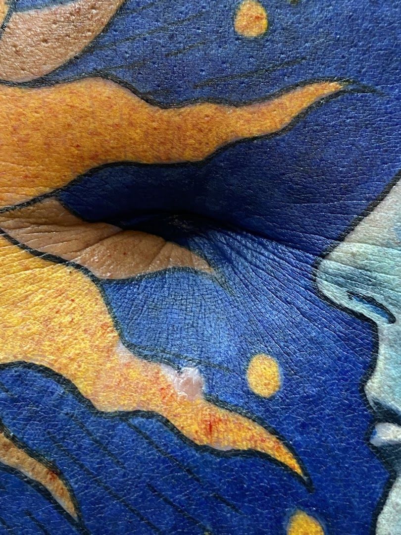 a close up of a person's face with a blue and yellow paint on it