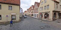 a street with buildings and a person walking down it