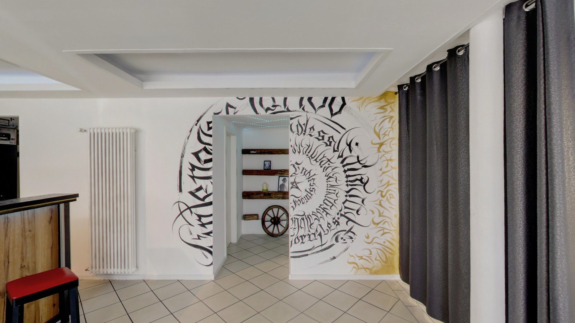 a kitchen with a mural on the wall