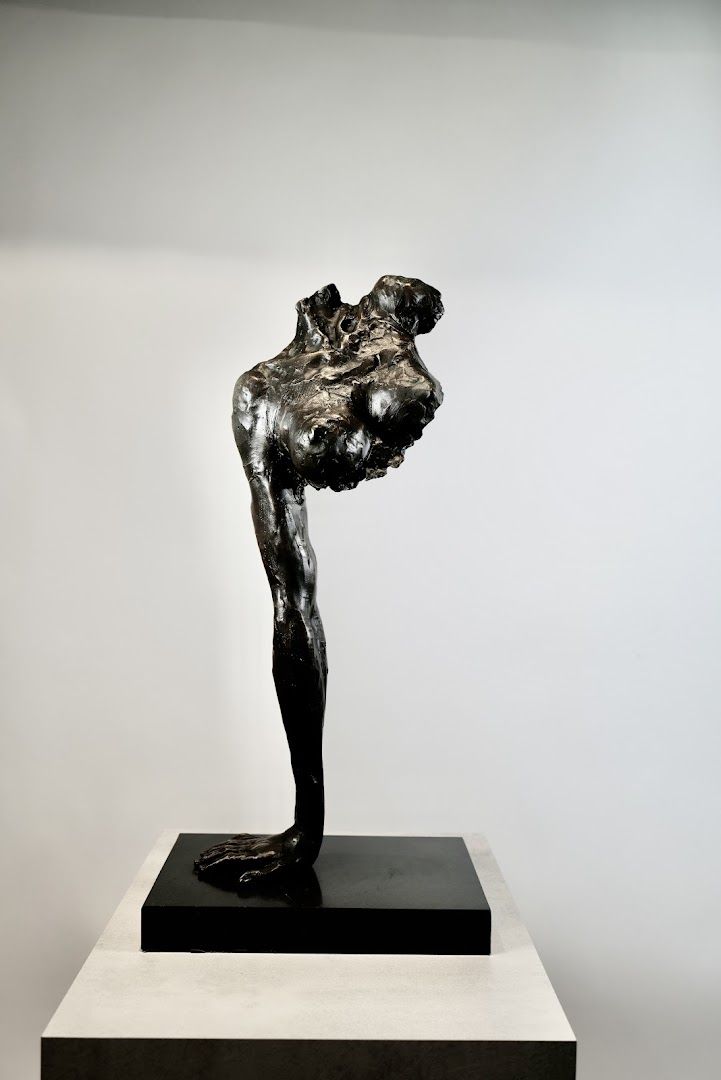 a sculpture of a man with his head in his hands