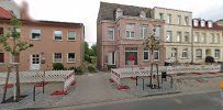 a street with buildings and a fence