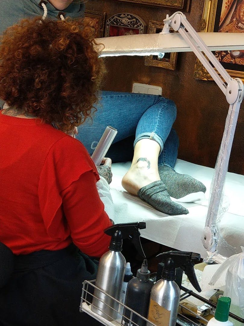 a woman sitting at a table with a pair of shoes