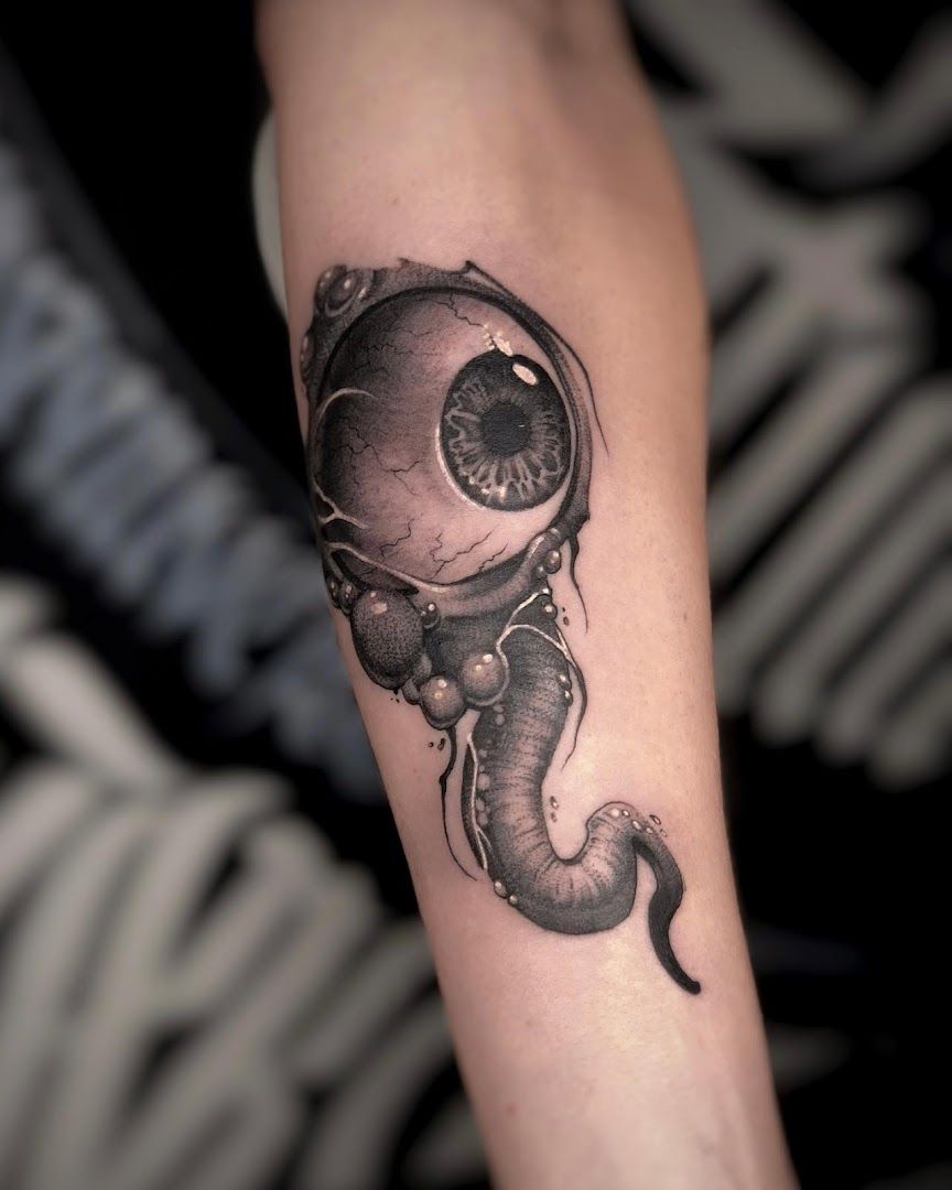 a black and white cover-up tattoo of an astronaut and a cat, berlin, germany