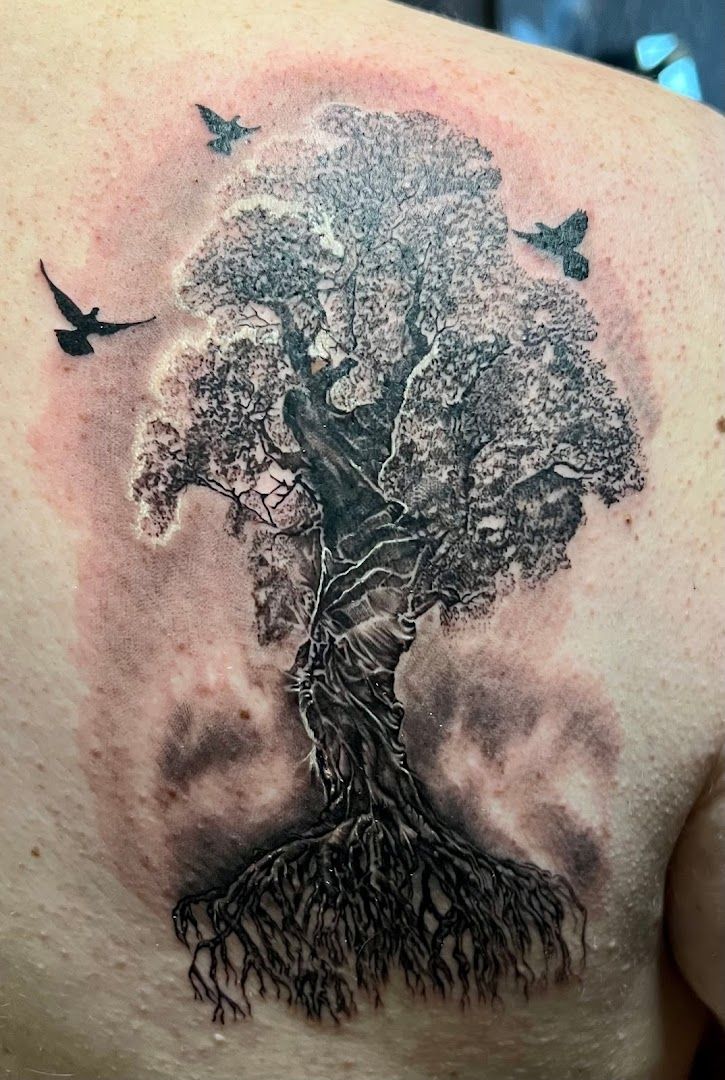 a narben tattoo of a tree with birds flying around it, bonn, germany