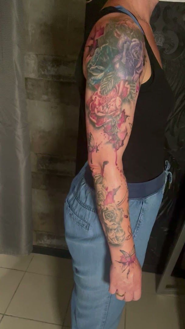 a woman with a cover-up tattoo on her arm, bielefeld, germany