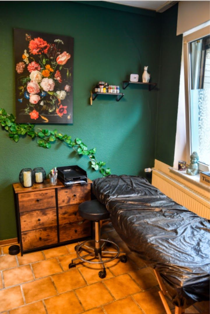 a room with a bed, desk and a painting