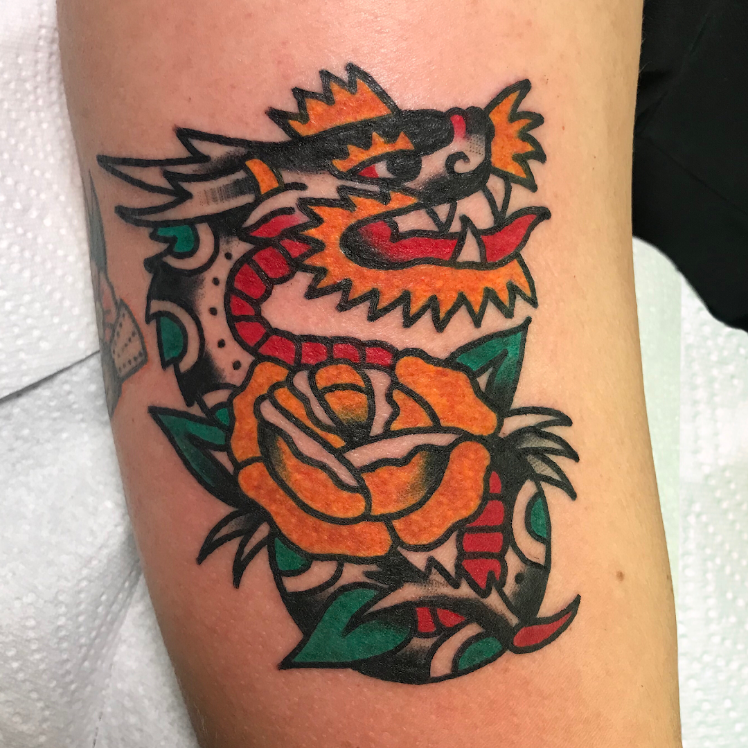 a narben tattoo with a dragon and roses on it, dresden, germany