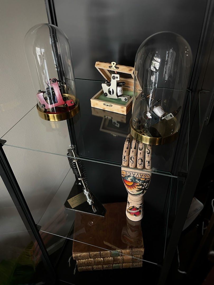 a glass shelf with a lamp and a wooden figure