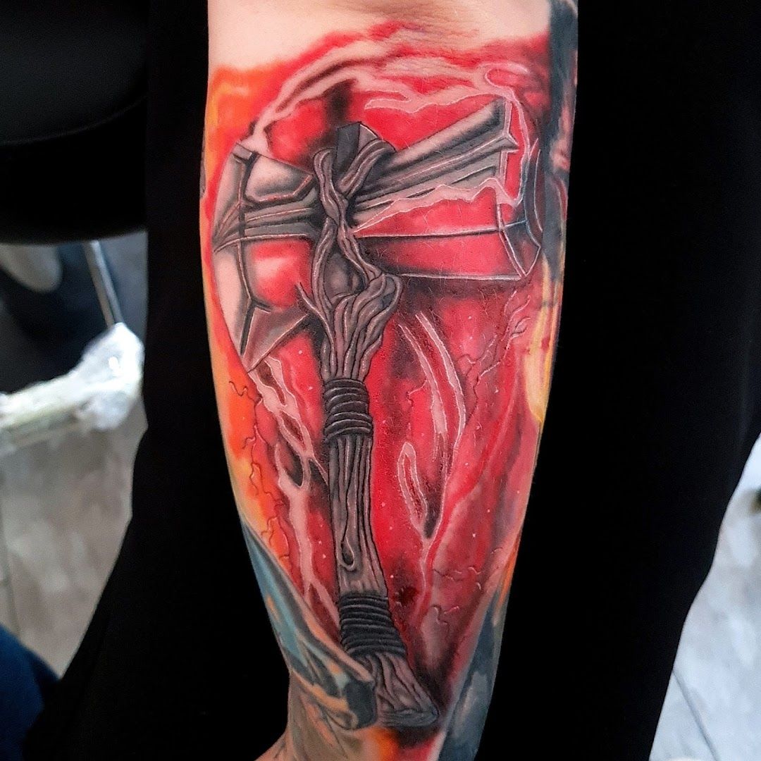 a cross cover-up tattoo on the arm, havelland, germany