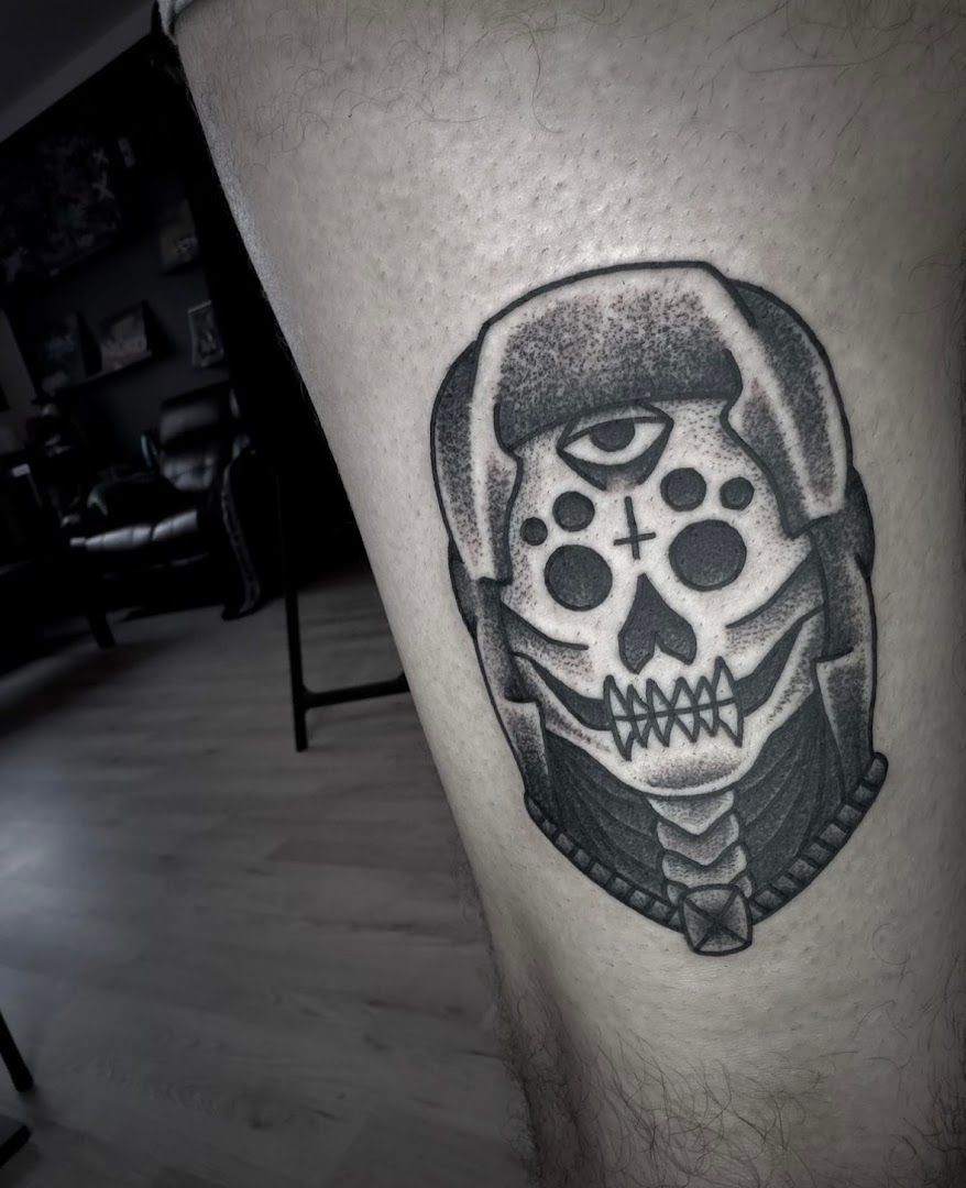 a skull with a hat and a bow tie on his leg