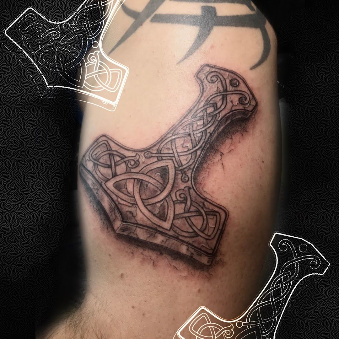 a narben tattoo of a cross with a celtic design on the arm, schleswig-flensburg, germany