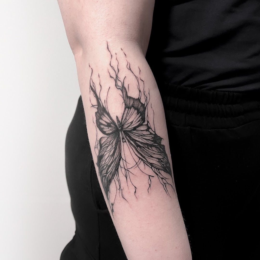 a woman's arm with a black and white cover-up tattoo design, kreisfreie stadt freiburg im breisgau, germany