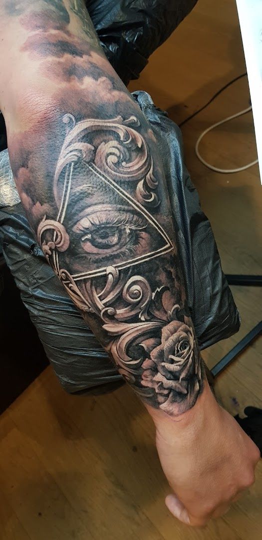 a cover-up tattoo of a demon with a demon on his arm, bielefeld, germany