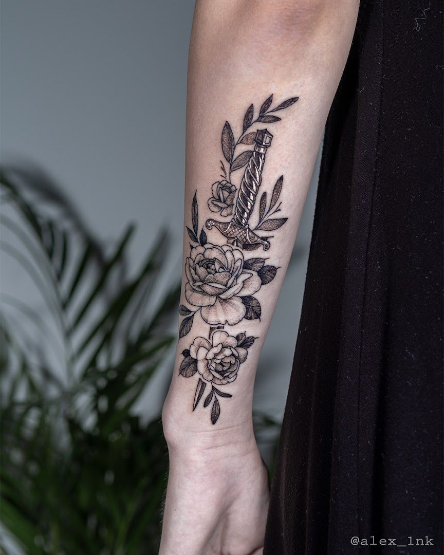 a woman's arm with a black and white cover-up tattoo design, ahrweiler, germany