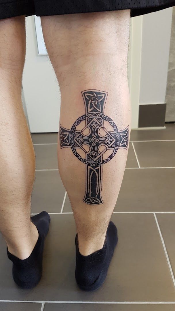 a man with a cross cover-up tattoo on his leg, munich, germany