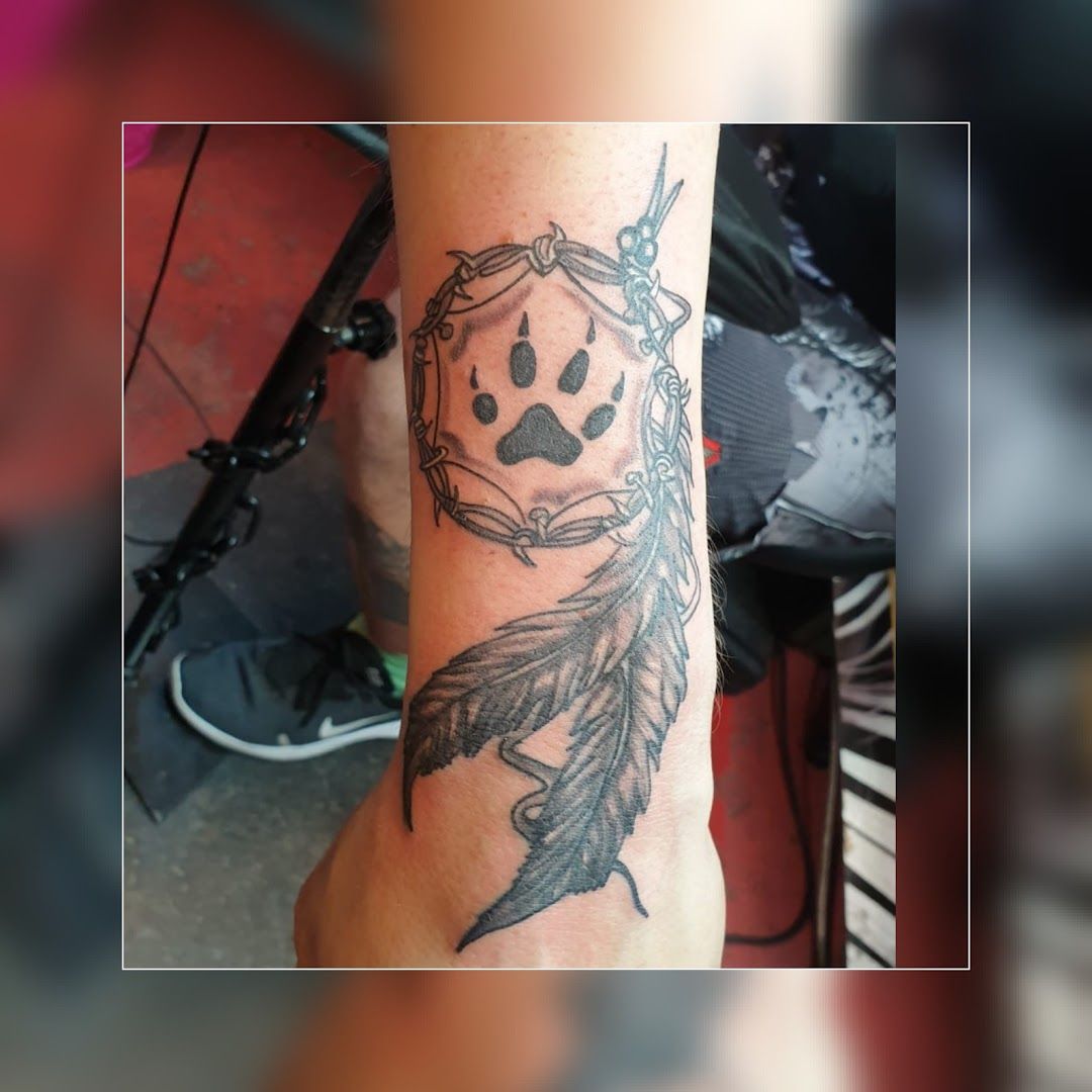 a narben tattoo with a skull and a feather, ravensburg, germany