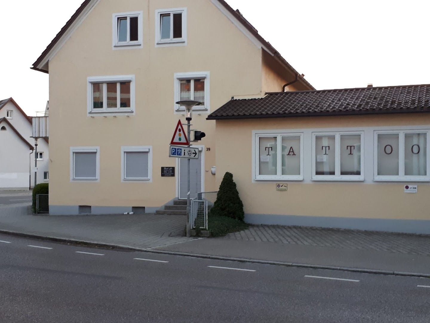 a yellow house with a white door and windows