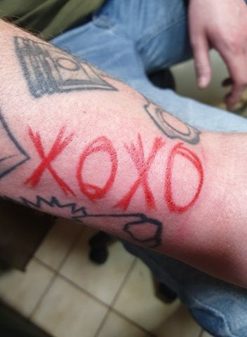 a man with a totenkopf tattoos on his arm, göttingen, germany