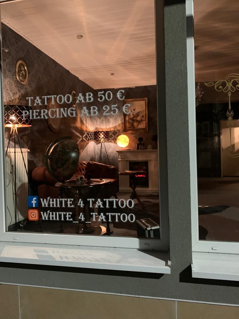 a window with a sign that says narben tattoo, germersheim, germany