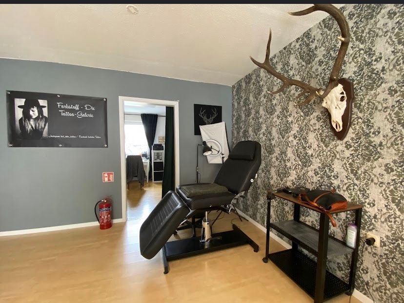 a room with a chair and a wallpapered wall