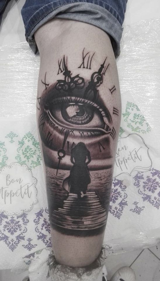 a blackwork tattoo of a woman's face with a cat on her leg, neumarkt, germany