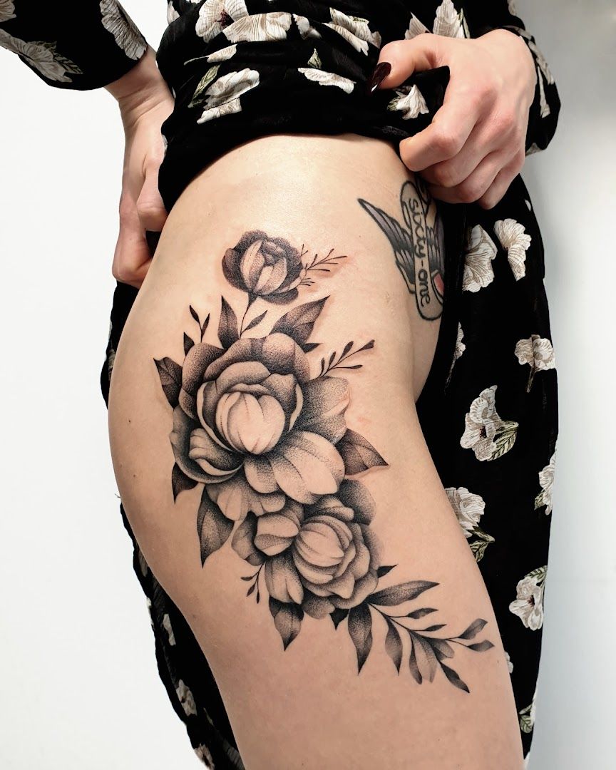 a woman's thigh with a black and white flower cover-up tattoo, essen, germany