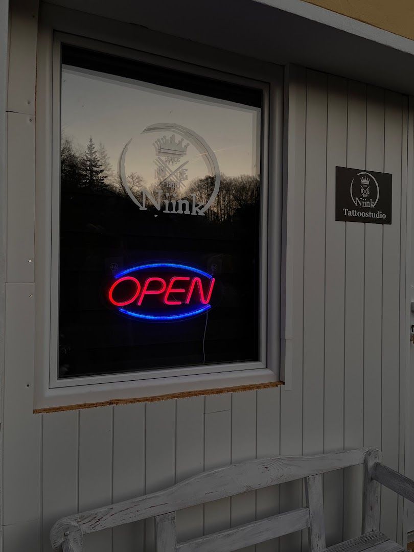 a window with a neon sign that reads open