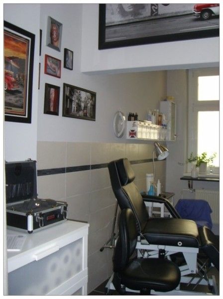 a room with a desk, chair and pictures on the wall