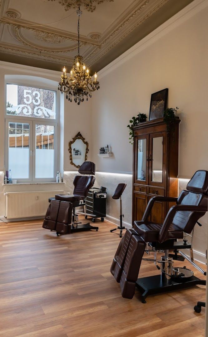 a salon with chairs and a chandel