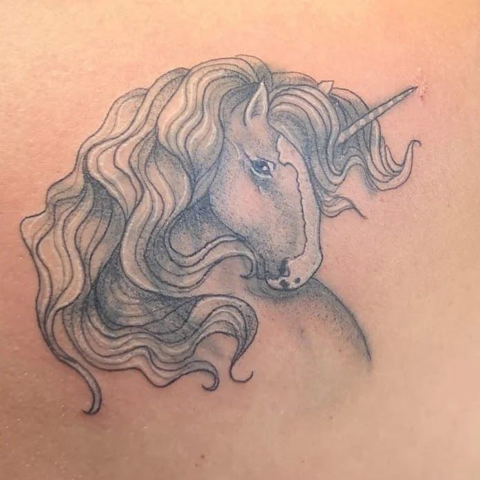 a narben tattoo of a unicorn with long hair, harburg, germany