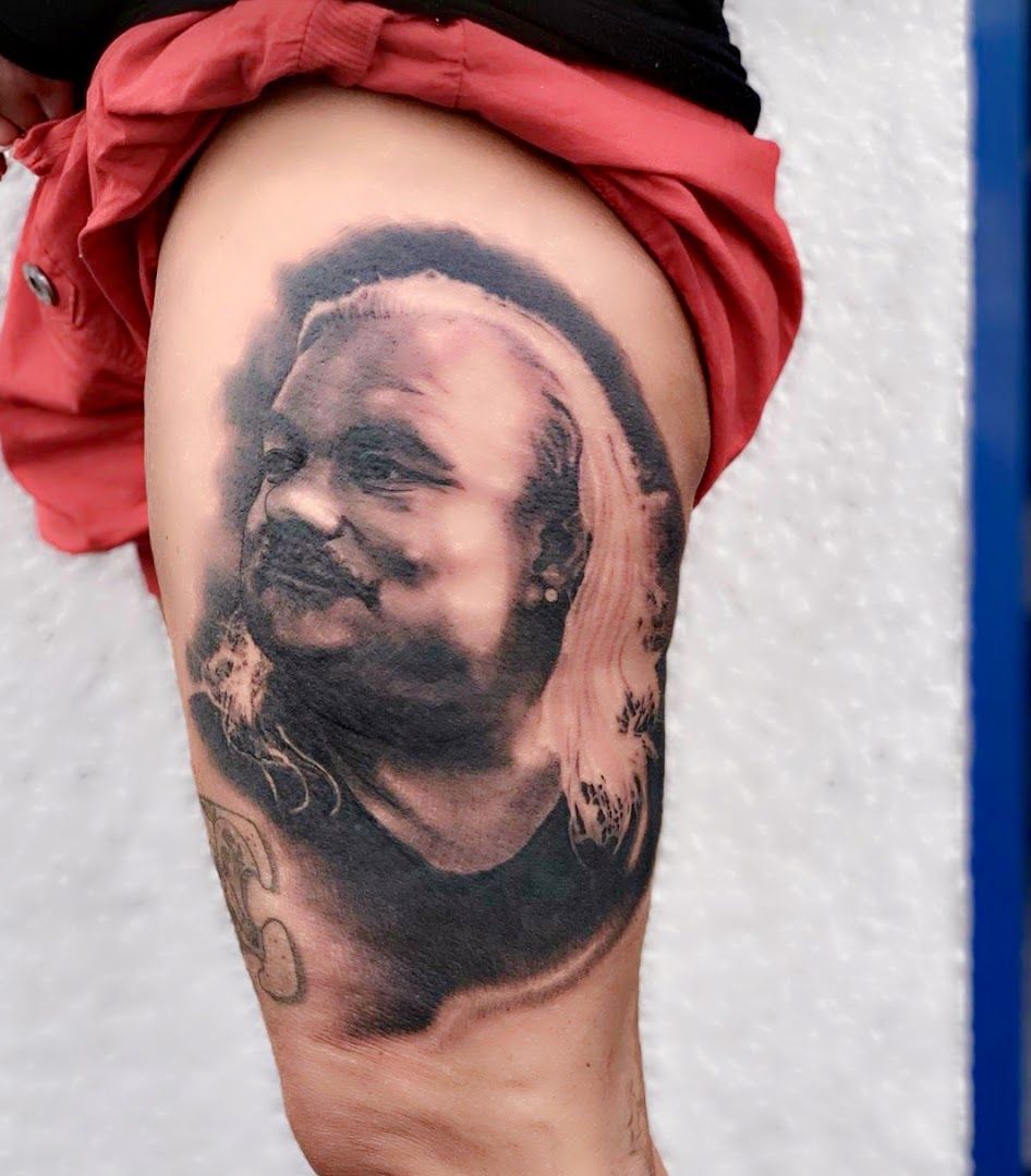 a cover-up tattoo of a man's face on the leg, darmstadt-dieburg, germany