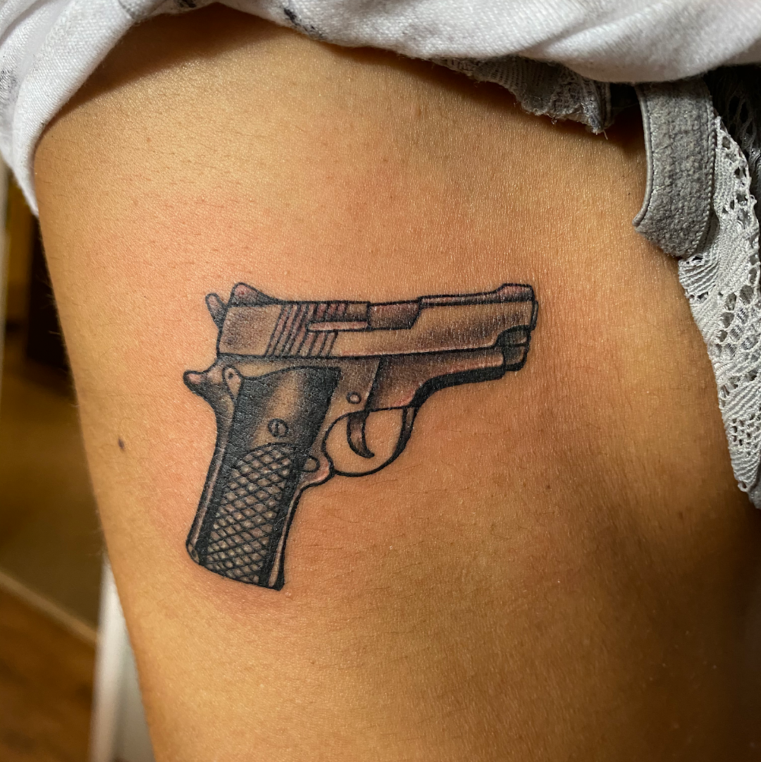 a tribal tattoo of a gun on the thigh, rhein-neckar-kreis, germany