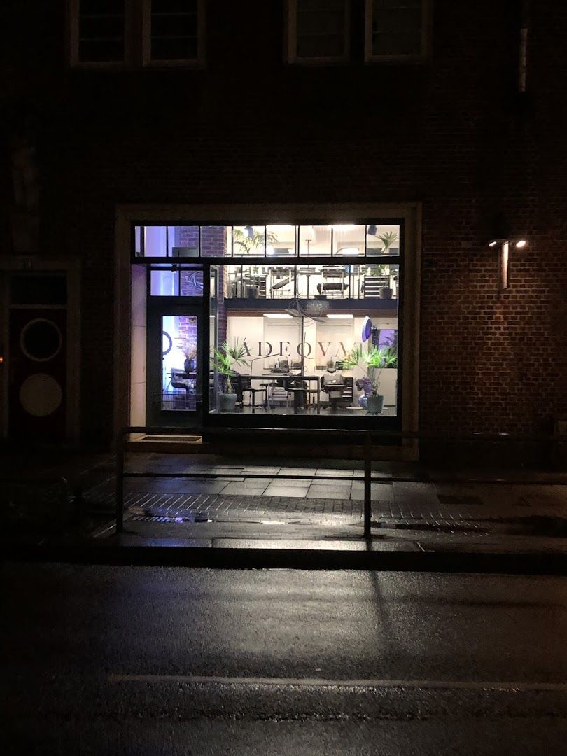 a store front at night with a lit window