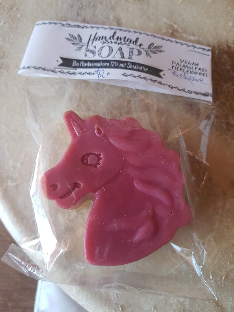 a pink horse shaped soap in a plastic bag