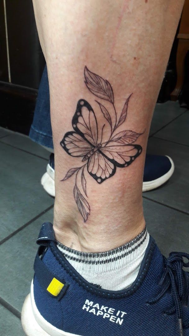 a black and white butterfly narben tattoo on the ankle, nordfriesland, germany