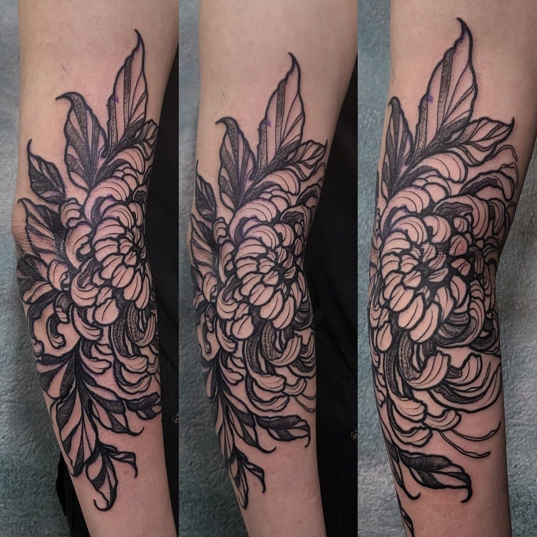 a black and white cover-up tattoo of flowers on the forearm, birkenfeld, germany