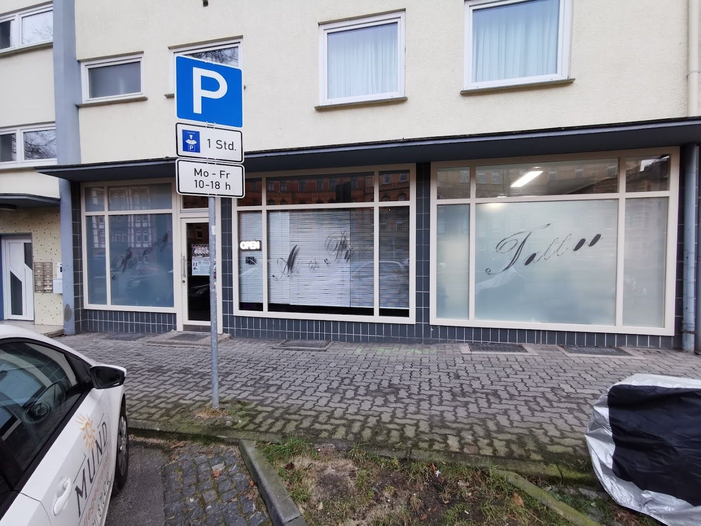 a parking sign in front of a building