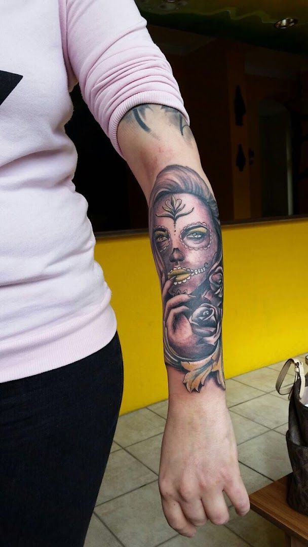 a woman with a cover-up tattoo on her arm, dresden, germany