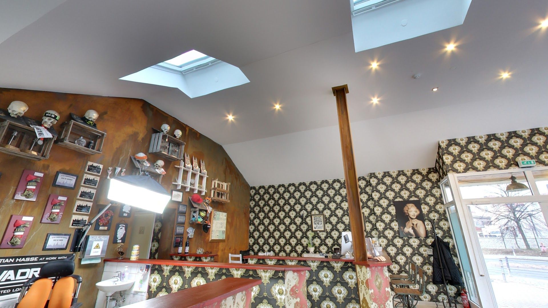 a room with a ceiling and a wallpapered wall