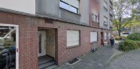 a street with cars parked in front of a building