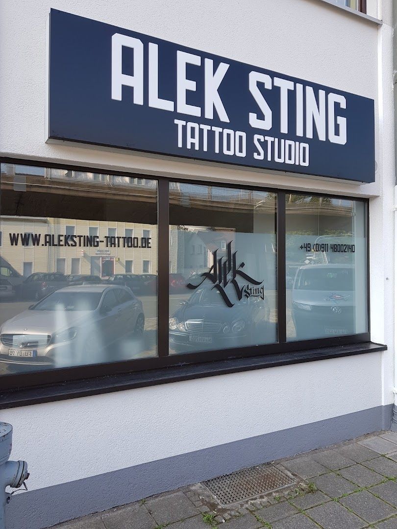 a store front with a sign that says kling cover-up tattoo studio, nürnberg, germany