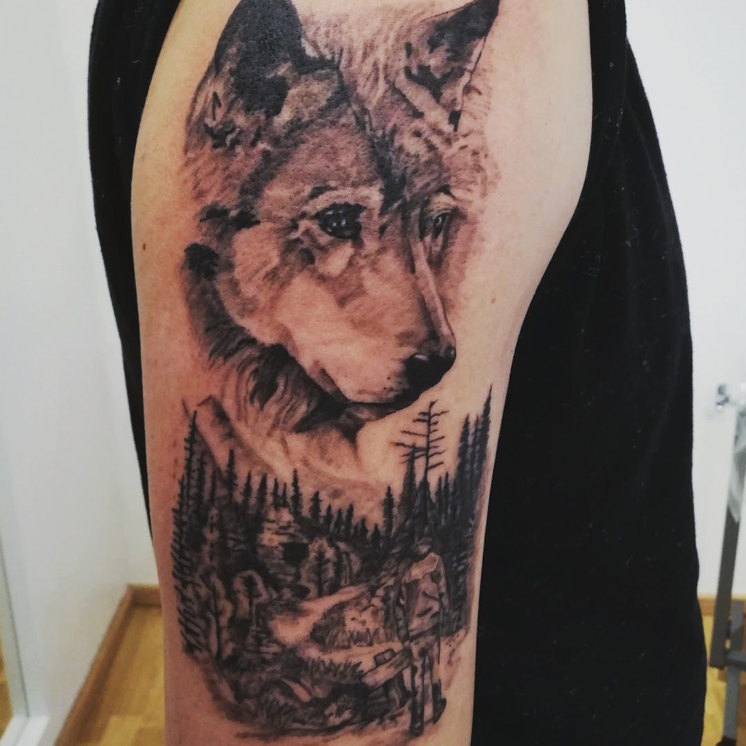 a wolf cover-up tattoo on the arm, regen, germany