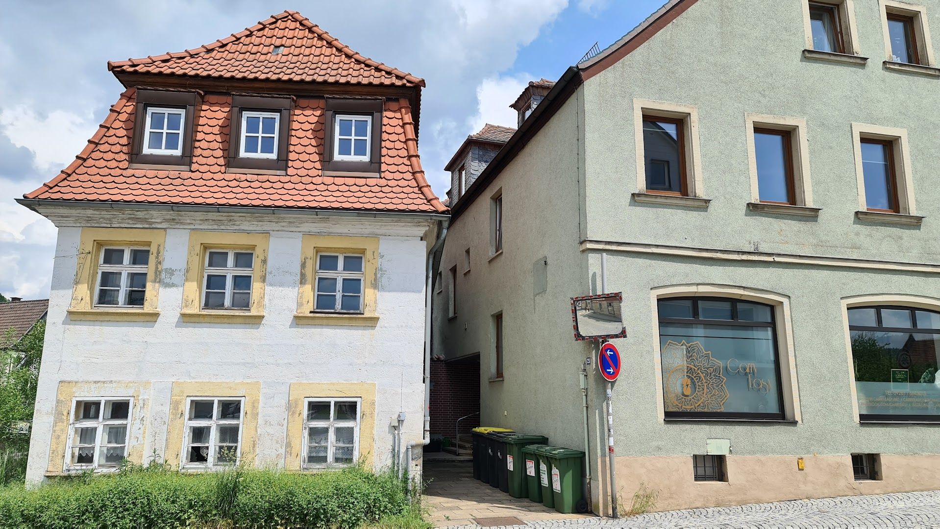 a house with a red roof and two windows