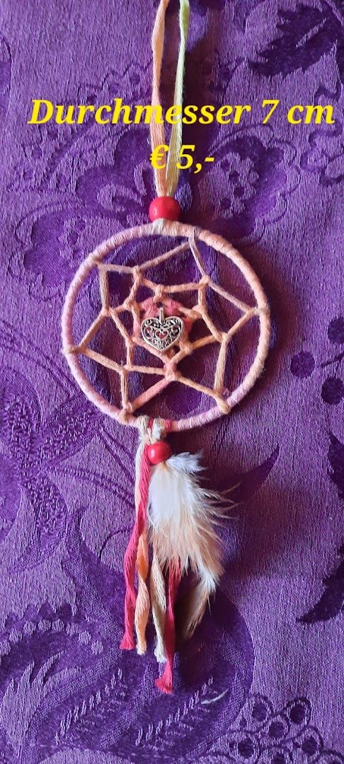 a dream catcher with feathers and a feathered dream