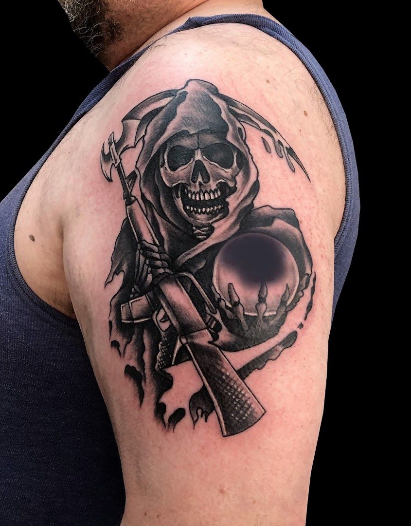 a skull with a gun and a skull on his shoulder