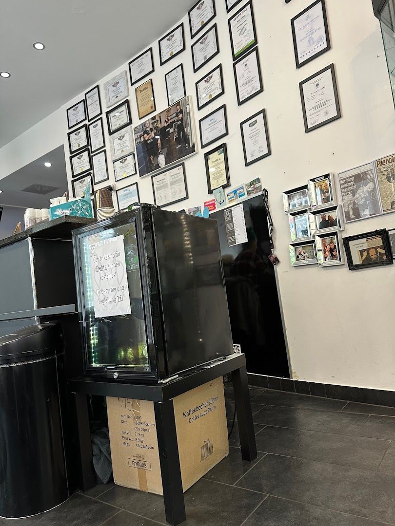 a black refrigerator sitting in a kitchen next to a wall