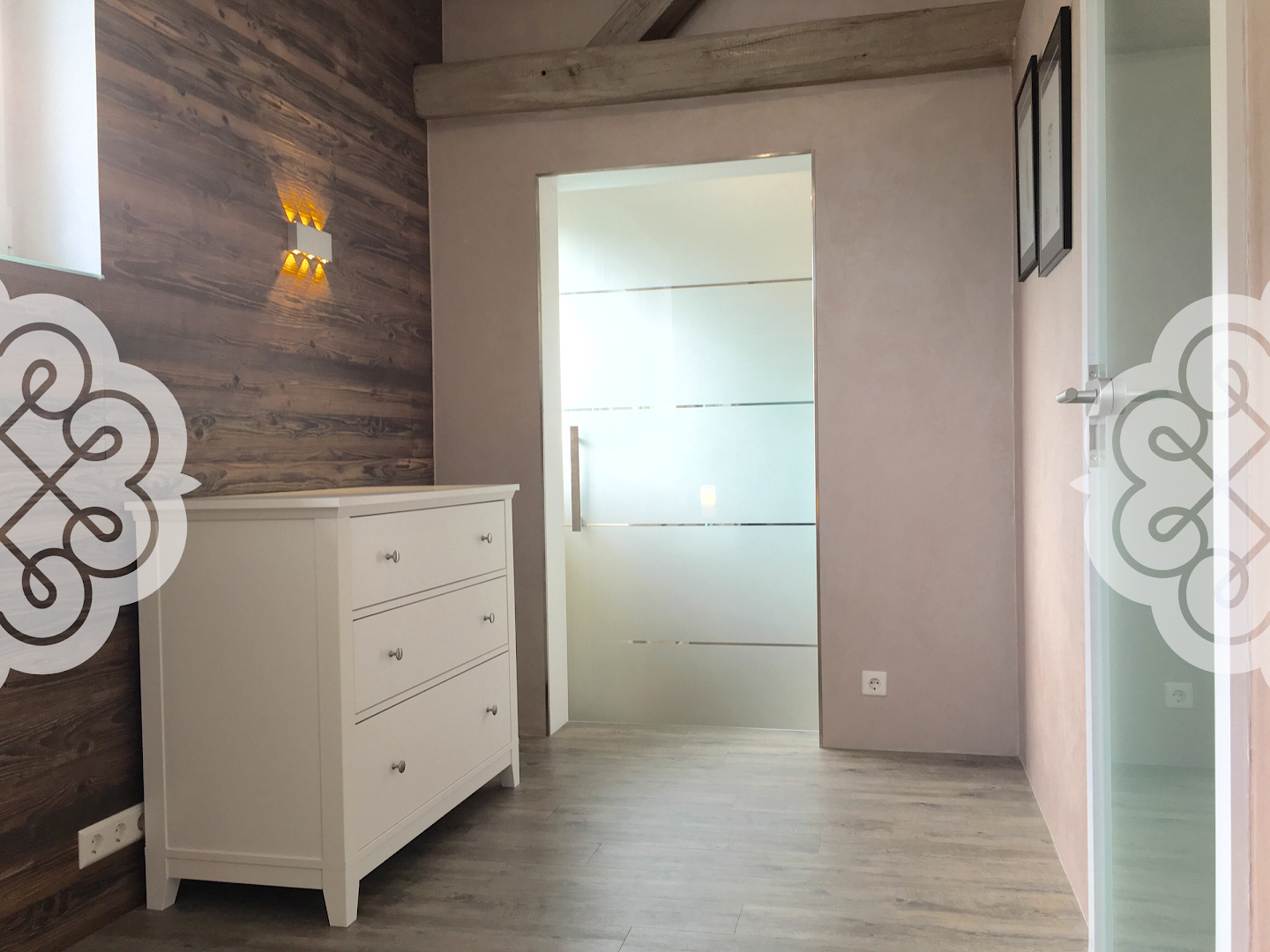 a bathroom with a wooden wall and a white vanity